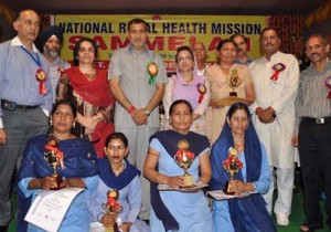 Minister for Health, Sham Lal Sharma giving mementoes to meritorious ASHA workers on Monday. Minister for Health, Sham Lal Sharma giving mementoes to meritorious ASHA workers on Monday.