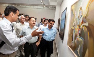 Dr Pawan Kotwal, Divisional Commissioner looking at the paintings displayed in Srijan Samooh’s maiden exhibition at Kala Kendra on Friday. Dr Pawan Kotwal, Divisional Commissioner looking at the paintings displayed in Srijan Samooh’s maiden exhibition at Kala Kendra on Friday.
