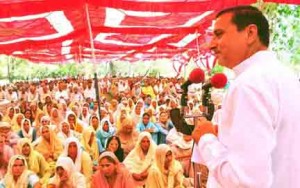 Minister for Health, Sham Lal Sharma addressing a public gathering on Tuesday.