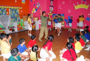 Children keenly watching resource person during a Theatre Workshop at KC Public School on Friday.