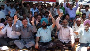 Employees staging protest dharna in front of Divisional Commissioner’s office in Jammu on Thursday.		-Excelsior/Rakesh