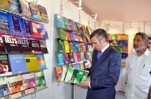 Chief Minister, Omar Abdullah reading a book after inaugurating book fair at S.P. College on Saturday.