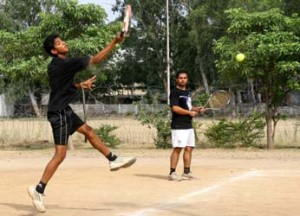 Player jumping and smashing during a semifinal match of Gulrez Memorial Lawn Tennis Tournament in Jammu on Thursday. Player jumping and smashing during a semifinal match of Gulrez Memorial Lawn Tennis Tournament in Jammu on Thursday.