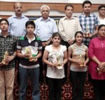 Students along with their parents and other dignitaries posing for a photograh after their felicitation at Jammu on Sunday. 	-Excelsior/Rakesh 