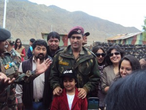 Indian cricket team Captain M S Dhonu interacting with Army officers' families and locals at Kargil on Wednesday.
