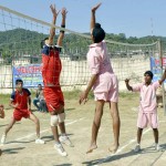 Spikers doing a samshing and blocking act during an Inter-District Volleyball Match at Youth Hostel Nagrota on Thursday.