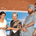 Sushma Chowdhary, retired IAS officer presenting trophy to a student during Bhajanwali in Jammu on Monday.