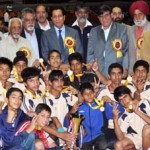 Young handball players showing victory signs while posing for a group photograph alongwith Speaker Mohd Akbar Lone and Minister for Sports R S Chib in Srinagar on Thursday.