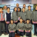 Children posing for a group photograph alonwith officials during Vigilance Awareness Week. on Saturday.