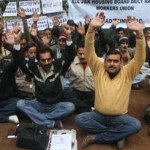 Housing Board workers staging protest dharna at Gandhi Nagar in Jammu on Thursday. - Excelsior/Rakesh