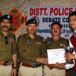 S P Kulbir Singh alongwith other police officials presenting trophy and certificate to the winner of debate competition at Kishtwar on Saturday.