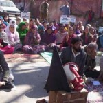 Workers of Bhaderwah Hospital Bachao Front sitting on dharna at Bhaderwah on Tuesday.