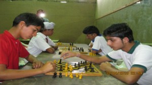 Young players busy in making moves while competing in Chess Tournament at Indoor Complex in MA Stadium on Thursday.