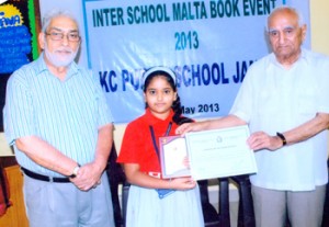 Chief guest VP Goswami presenting a certificate to the winner during Maltese Book Competition hosted by KC Public School on Tuesday.