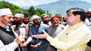 Minister for Forest Mian Altaf Ahmad interacting with residents during his visit at Kangan on Sunday.