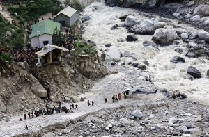 Soldiers assist survivors to board a rescue helicopter next to the River Alaknanda, during rescue operations in Govindghat in the Himalayan state of Uttarakhand on Saturday. (UNI)