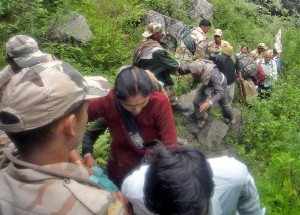 Stranded and injured pilgrims being evacuated by ITBP personnel through a temporary lader from the remote parts of Badrinath on Sunday. (UNI)