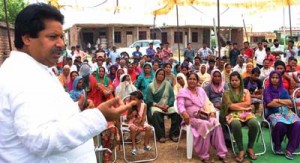 Minister for Horticulture Raman Bhalla addressing public gathering at Joogian Mohalla on Sunday.