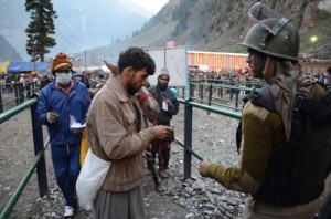 Security personnel checking the passes of Amarnath pilgrims at the base camp of Baltal on Thursday. (UNI)