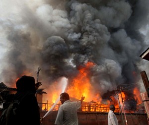 Flames rising out of a Civil Secretariat building in Srinagar on Thursday. (Another pic on page 6) -Excelsior/Amin War