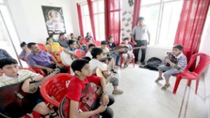 Instructor Anil Sharma bestowing tips to guitarists during a workshop in Jammu on Sunday. Excelsior/Rakesh