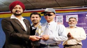 Deputy Commissioner Leh Simrandeep Singh giving prizes during Science Gadgets programme.