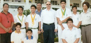 Medal winning swimmers of DPS posing alongwith their Principal, Sudarshan Sonar.