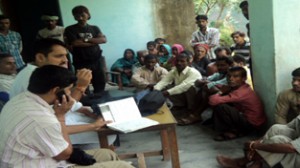 Youth Cong leader R S Pathania interacting with rain hit people at Ramnagar.