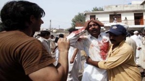 A man cries at the death of his brother at the site of a suicide blast at a Church in Peshawar on Sunday. (UNI)