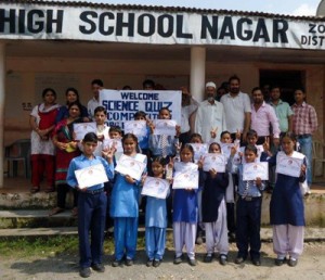 Winners of quiz competition holding certificates while posing for a group photograph.