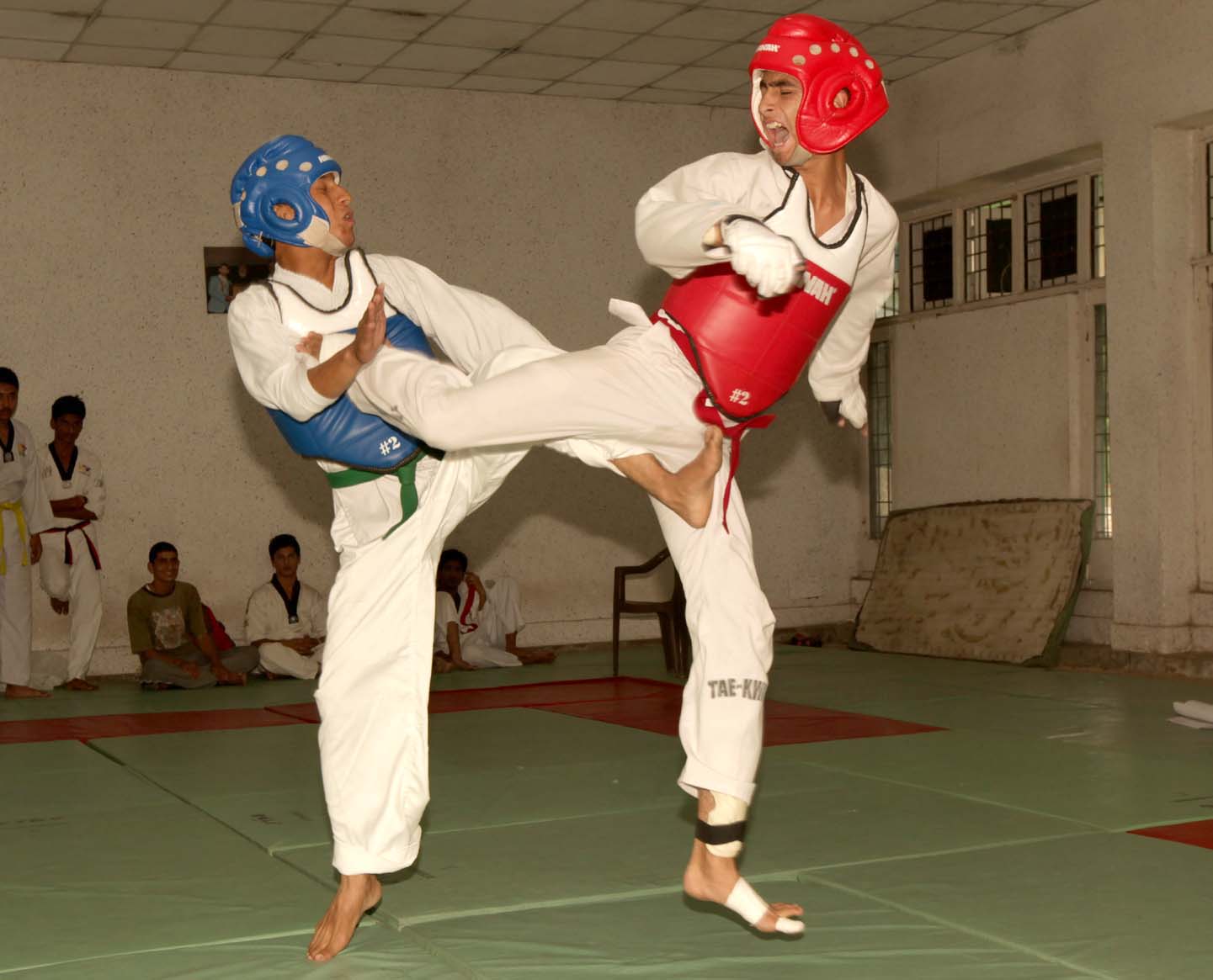 Players displaying their skill during a bout of Inter-Division Under-19 boys and girls Taekwondo Championship in Jammu on Monday. -Excelsior/ Rakesh