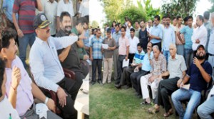 JMC Commissioner Kiran Wattal interacting with residents during public grievances camp on Friday. -Excelsior/Rakesh