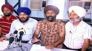 Sikh employees talking to reporters at Jammu on Saturday.