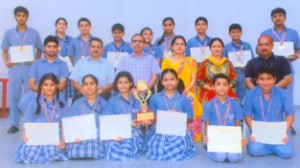 Swimmers of KC Public School posing for a group photograph alongwith Principal and coaches.