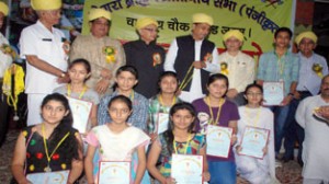 Minister for PHE, Sham Lal Sharma and Dogra Brahman Pratinidhi Sabha members with meritous students posing for photograph during a function on Sunday. —Excelsior/Rakesh