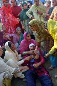 Women wailing over the body of murdered youth in Rajouri on Friday. —Excelsior/Bhat
