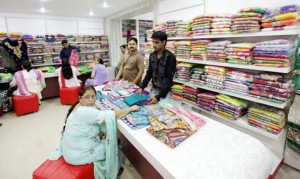 Customers purchasing sarees and suits from newly opened showroom ‘Chaman Suits & Sarees’ at Apsara Road on Friday. -Excelsior/Rakesh