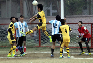 Jumping in air footballer heading the ball to send it into the nets during a match of Senior Division Football Tournament in Jammu on Friday. —Excelsior/Rakesh