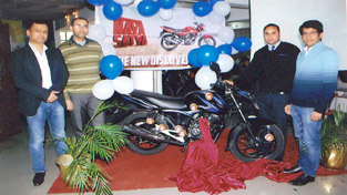 Vineet Aggarwal, Director Jammu Motors, Yogesh Anand (ASM), Rajesh Gupta (Manager) in presence of dealers of Bajaj, financer and customers at the unveiling of Discover 100M.