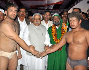 Minister for Planning Ajay Sadhotra declaring joint winners of wrestling competition.
