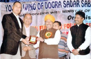 Former Minister, Gulchain Singh Charak felicitating coach for his outstanding contribution in athletics in Bishnah zone.