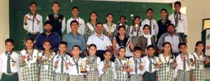 Medal winners in Kick Boxing Championship posing alongwith Principal and staff members of Humanity Public School on Friday.