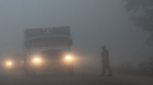 A truck with head-lights on plying on Jammu road amidst dense fog on Wednesday. —Excelsior/Rakesh