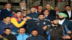 Athletes posing alongwith Sports Minister Taj Mohi-ud-Din during concluding function of J&K State Athletic Championship.