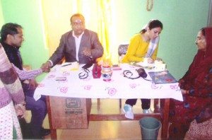 Homoeopath Dr Shakti Dhar along with other doctor examining the patients during free medical camp at Billawar.
