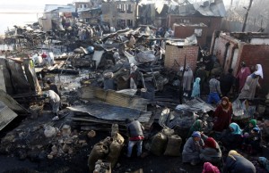 People look at the debris of  their  residential houses after a massive fire at Dhobi Ghat, Hazratbal on the outskirts of Srinagar. —Excelsior/Amin War