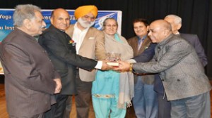 JU VC Prof MPS Ishar and others presenting memento during a seminar on Yoga on Sunday.