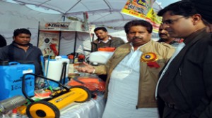 Minister for Horticulture Raman Bhalla inspecting stalls during Fruit Show-cum-Seminar at Jammu on Sunday.