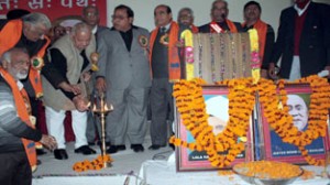 Prof Chaman Lal Gupta lighting the traditional lamp at a function at Jammu on Sunday. -Excelsior/ Rakesh