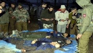 Army soldiers and police jawans at the site of encounter along with bodies of three militants at Dooru, Sopore on Monday. — Excelsior/Aabid Nabi